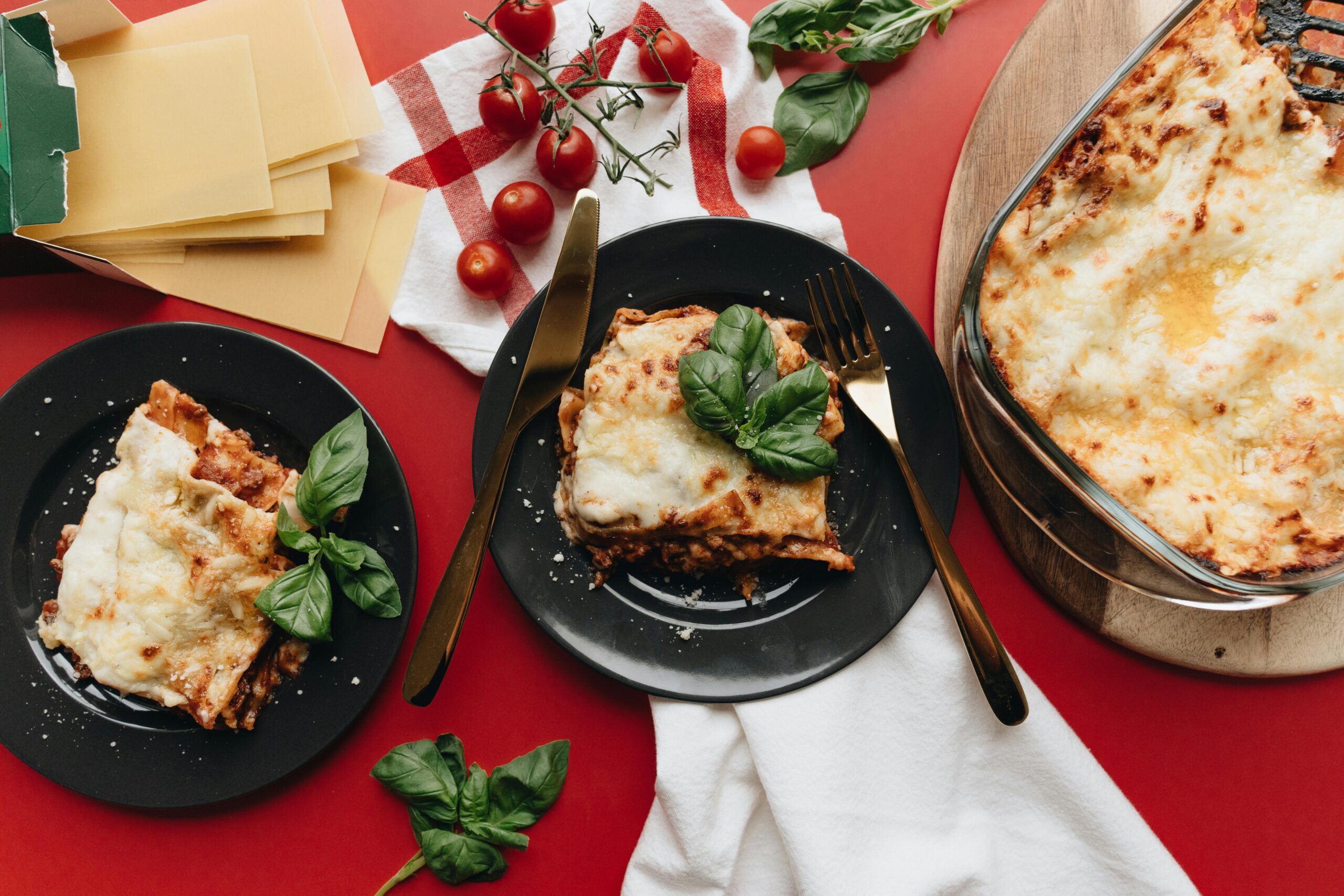 pexels photo 5949889 5949889 Delicious homemade lasagna with fresh basil and cherry tomatoes, perfect for food lovers.